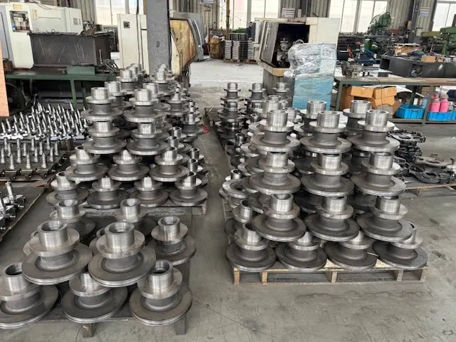 Rows of precision-machined steel wheel hubs and axle components staged for assembly at the Harlan Global production plant.