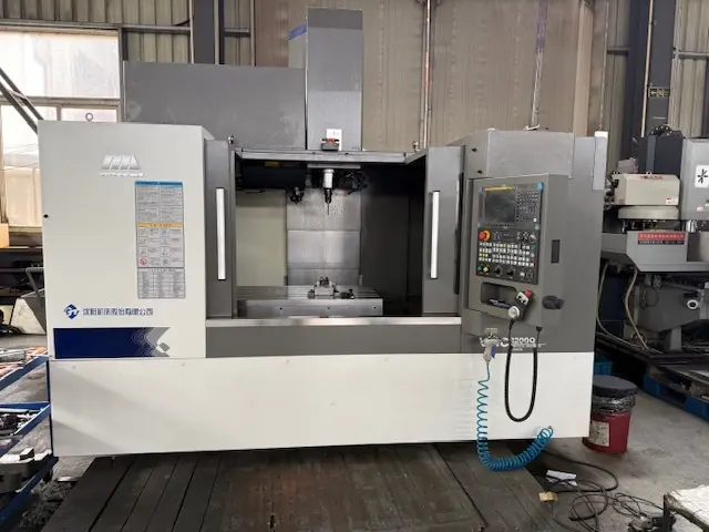 A precision VMC CNC machining center used at the Harlan Global manufacturing facility to produce custom industrial parts and ground support equipment components.