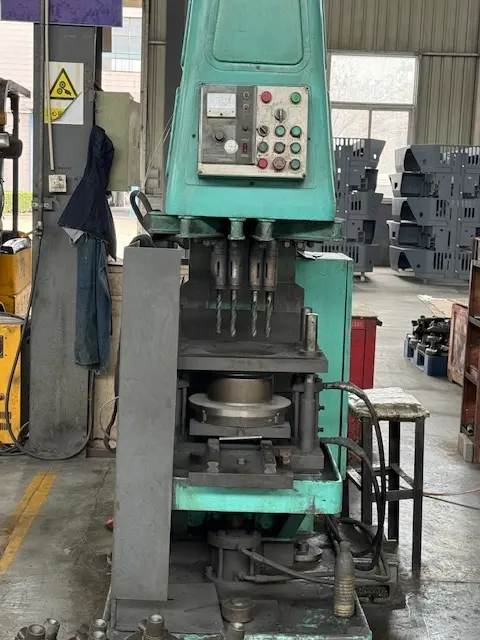A multi-spindle industrial drill press at the Harlan Global production facility precision-drilling heavy-duty metal components for aircraft tow tractors and ground support equipment.