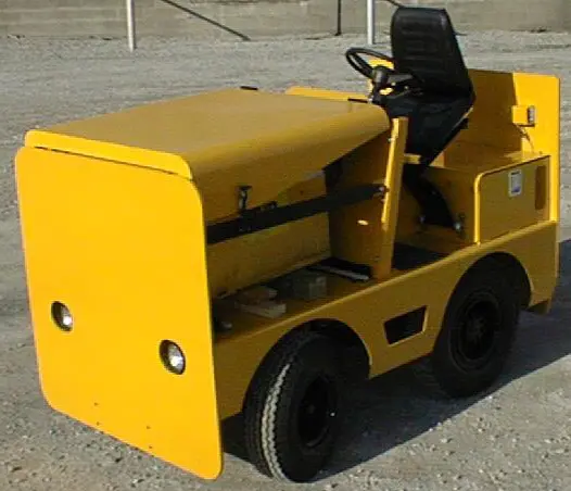A yellow Harlan HKE40 electric tow tractor designed for sustainable cargo transport, featuring a heavy-duty chassis and an 80V AC drive motor for efficient airport ground handling.