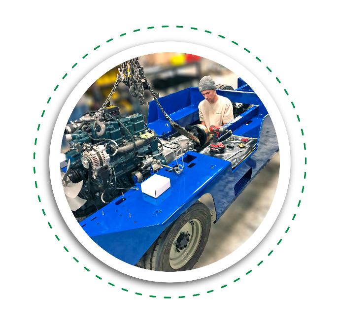 Harlan Global engineer inspecting a vehicle in the service shop, ensuring quality and performance of ground support equipment.